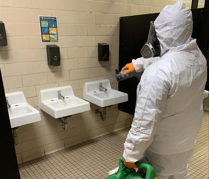 SERVPRO technician cleaning a bathroom
