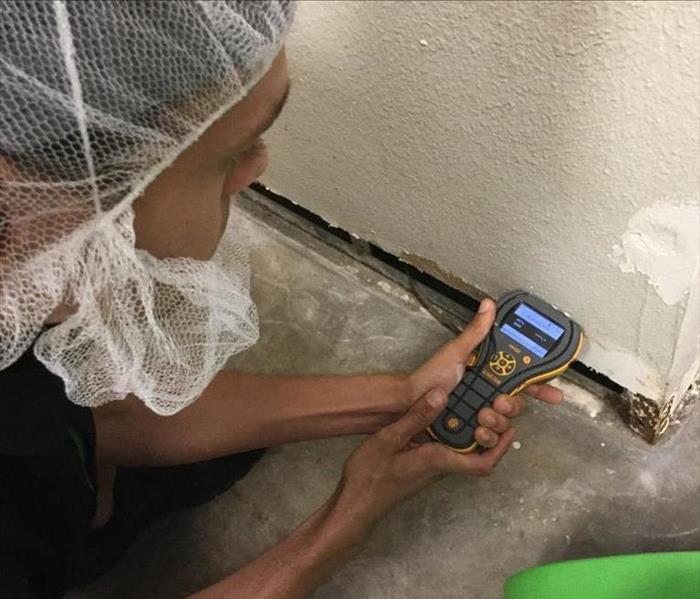 SERVPRO technician checking for moisture in a Lakeland, FL business